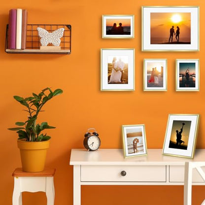Frametory 7 Pack Aluminum Picture Frame with Mat for Gallery Wall, Gold | Set includes one 11x14, two 8x10, four 5x7 frames with glass fronts, removable mats, and built-in hangers for wall mounting - color: Gold