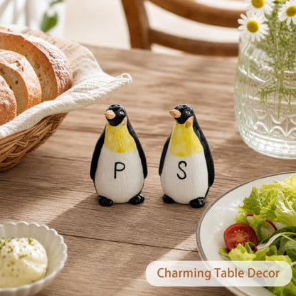 Ceramic Penguin Salt and Pepper Shakers Set Refillable Seasoning Dispensers | Set of 2 hand-painted ceramic penguin salt and pepper shakers with clear "S" and "P" labels and silicone stoppers.